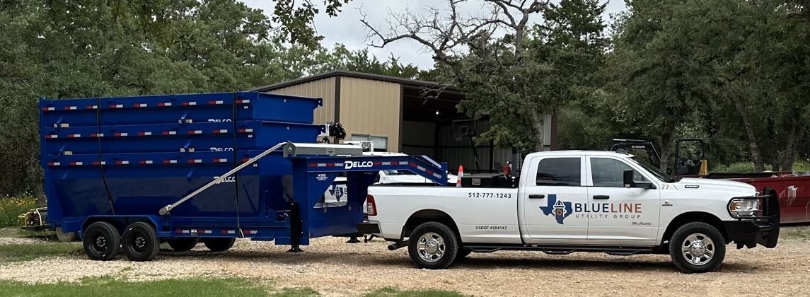 Blue Line Utility Group truck with blue roll-off dumpster trailer
